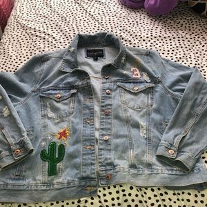 Forever 21 blue jean jacket with sticker designs.